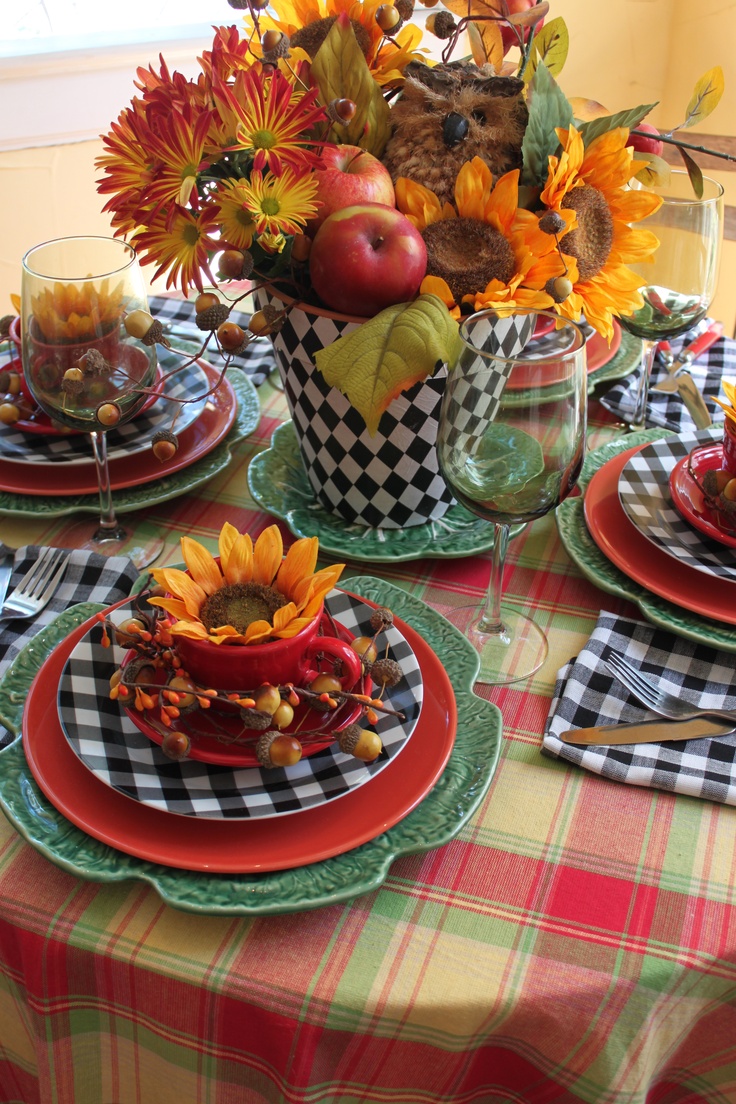 A holiday table setting with burlap, pumpkins, and faux leaves